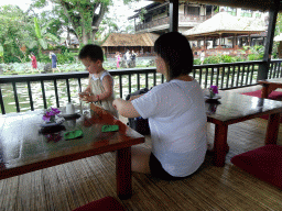 Miaomiao and Max at the terrace of Café Lotus, with a view on the pond with lotus plants