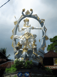 Large statue at the crossing of the Jalan Raya Ubud street and the Jalan Cokorda Gede Rai street, viewed from the taxi