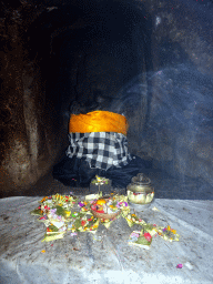 Ganesha statue with offerings in the `Elephant Cave` at the Goa Gajah temple