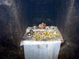 Statue with offerings in the `Elephant Cave` at the Goa Gajah temple