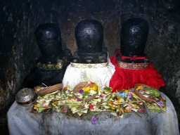 Trilinga statues with offerings in the `Elephant Cave` at the Goa Gajah temple