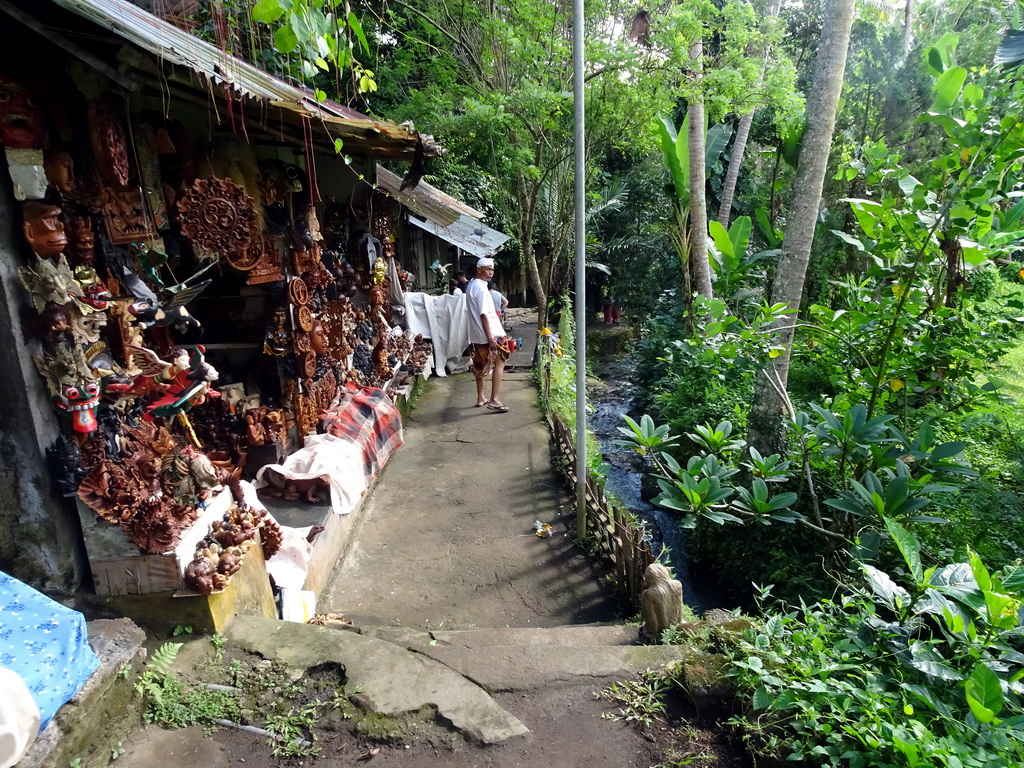 Our tour guide and a souvenir shop at the path to the lower part of the Goa Gajah temple