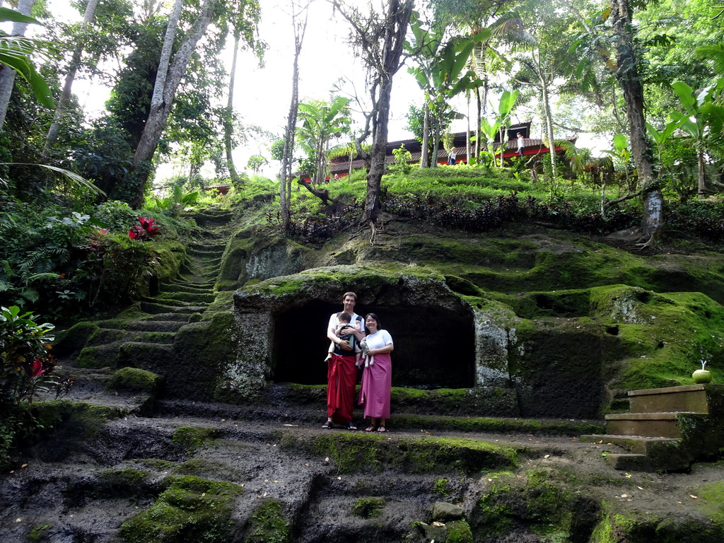 Tim, Miaomiao and Max in front of a small cave at the lower part of the Goa Gajah temple