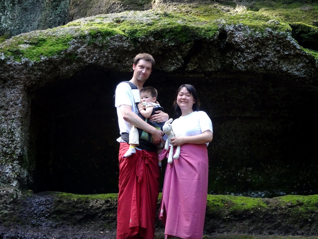 Tim, Miaomiao and Max in front of a small cave at the lower part of the Goa Gajah temple