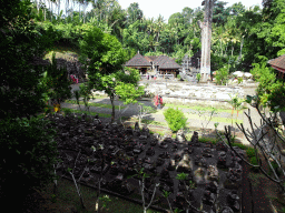 Ruins, large tree, the Pura Taman temple and the `Elephant Cave` at the Goa Gajah temple, viewed from the path to the entrance