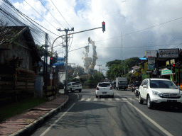 Large statue at the crossing of the Jalan Raya Ubud street and the Jalan Cokorda Gede Rai street, viewed from the taxi going to Tegalalang