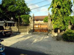 Entrance gate to a building at the Jalan Raya Uluwatu street at Ungasan, viewed from the taxi to Nusa Dua