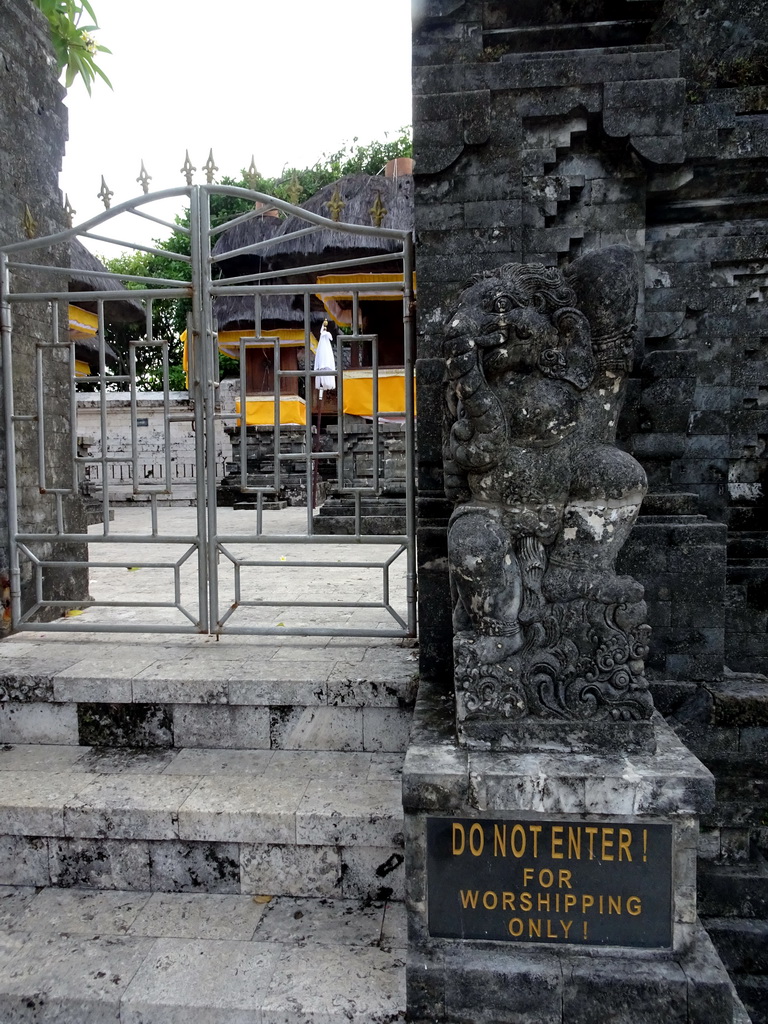 Gate with a statue at the Pura Luhur Uluwatu temple