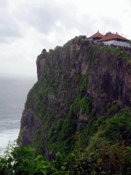 Cliff with pavilions at the Pura Luhur Uluwatu temple, viewed from the path to the Amphitheatre