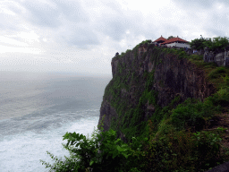 Cliff with pavilions at the Pura Luhur Uluwatu temple, viewed from the path to the Amphitheatre