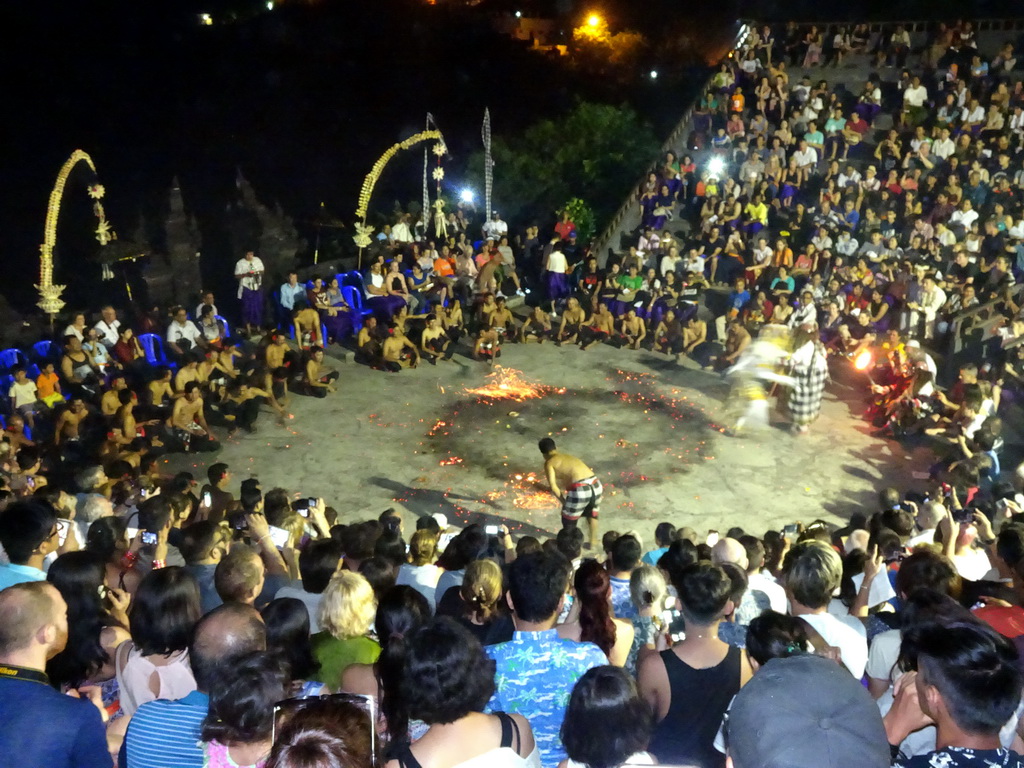 The Amphitheatre of the Pura Luhur Uluwatu temple, with Haruman dancing with tourists during Act 4 of the Kecak and Fire Dance, by night
