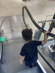 Max on a escalator at the Bijenkorf department store