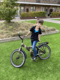 Max on a bicycle at the central square of the apartment block at the Aidadreef street