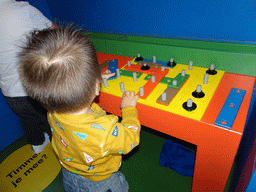 Max playing with carpentry toys at Nijntje`s House at the ground floor of the Nijntje Museum