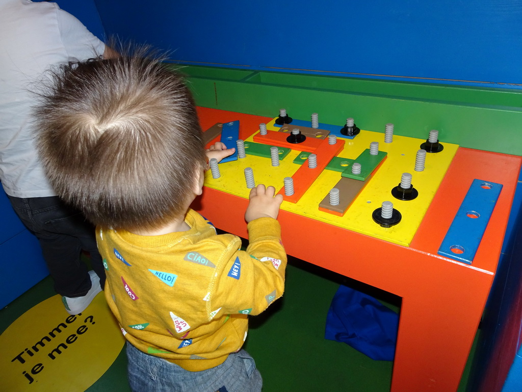 Max playing with carpentry toys at Nijntje`s House at the ground floor of the Nijntje Museum