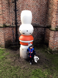 Max with a statue of Nijntje at the inner garden of the Centraal Museum