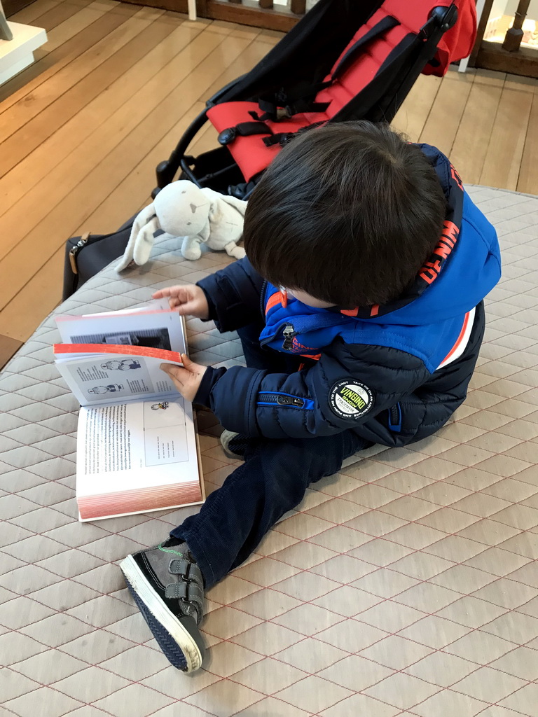 Max with a book about Dick Bruna at the upper floor of the Museum Shop of the Centraal Museum