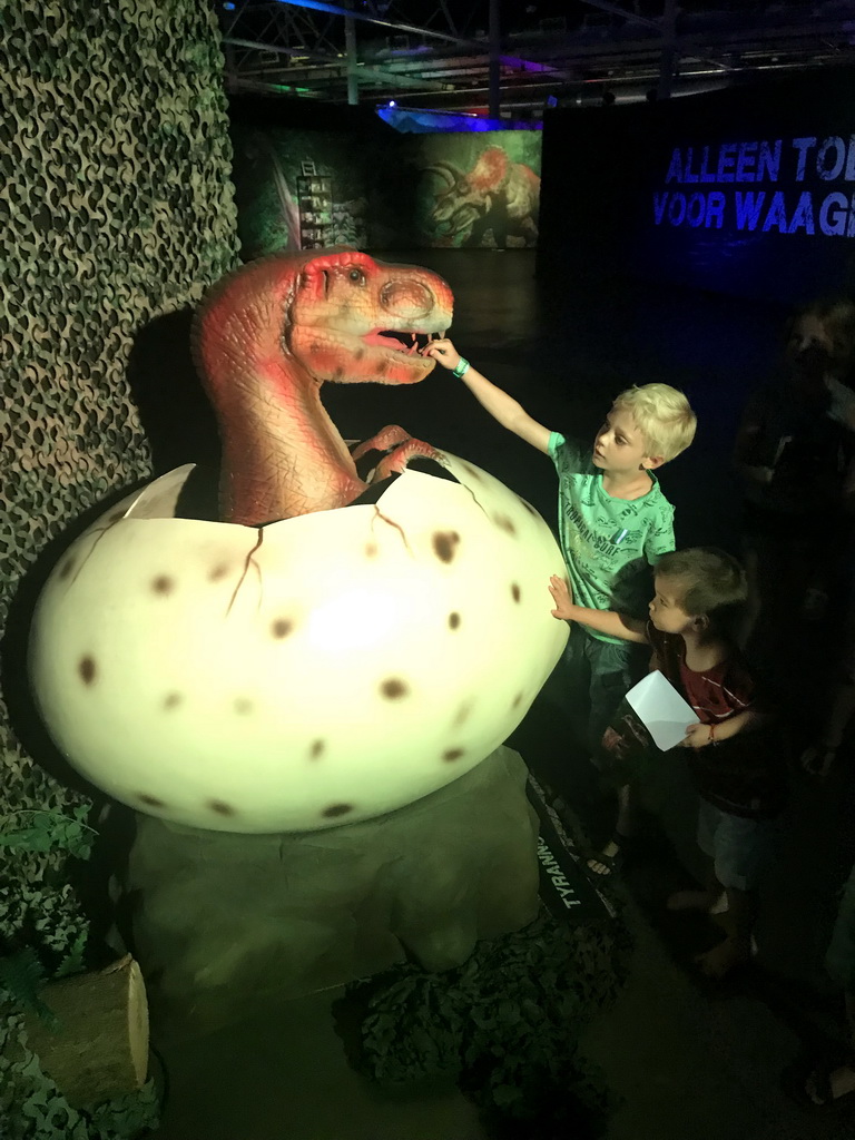 Max with a Tyrannosaurus Rex in a egg statue at the World of Dinos exhibition at the Jaarbeurs building