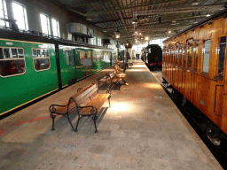 Old trains and a bronze statue at the `Treinen door de Tijd` exhibition at the Werkplaats hall of the Spoorwegmuseum