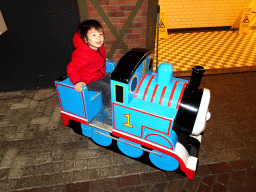 Max on the Thomas the Tank Engine rocking train in front of the De Remise restaurant at the Werkplaats hall at the Spoorwegmuseum