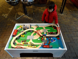 Max playing with model trains in front of the Spoorwinkel De Loods souvenir shop at the Werkplaats hall of the Spoorwegmuseum