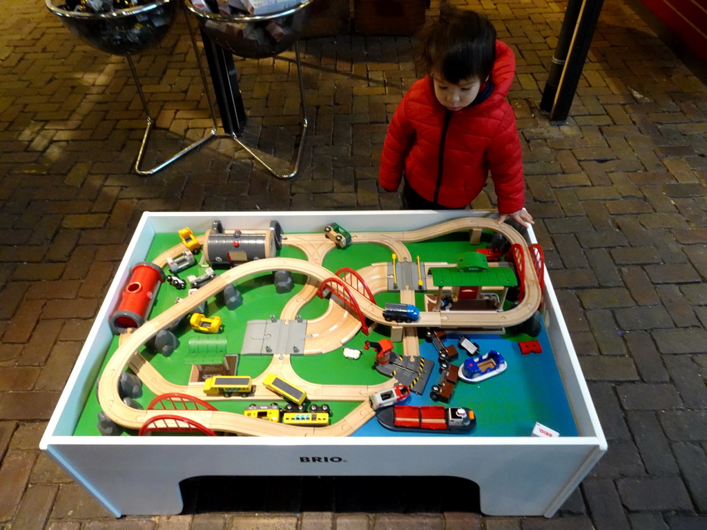 Max playing with model trains in front of the Spoorwinkel De Loods souvenir shop at the Werkplaats hall of the Spoorwegmuseum