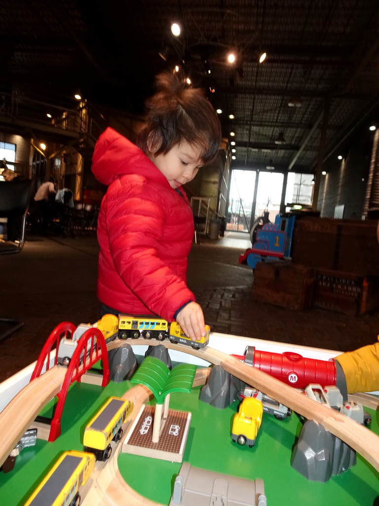 Max playing with model trains in front of the Spoorwinkel De Loods souvenir shop at the Werkplaats hall of the Spoorwegmuseum