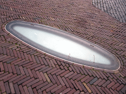 Window in the ceiling of the DomUnder exhibition, viewed from the Domplein square