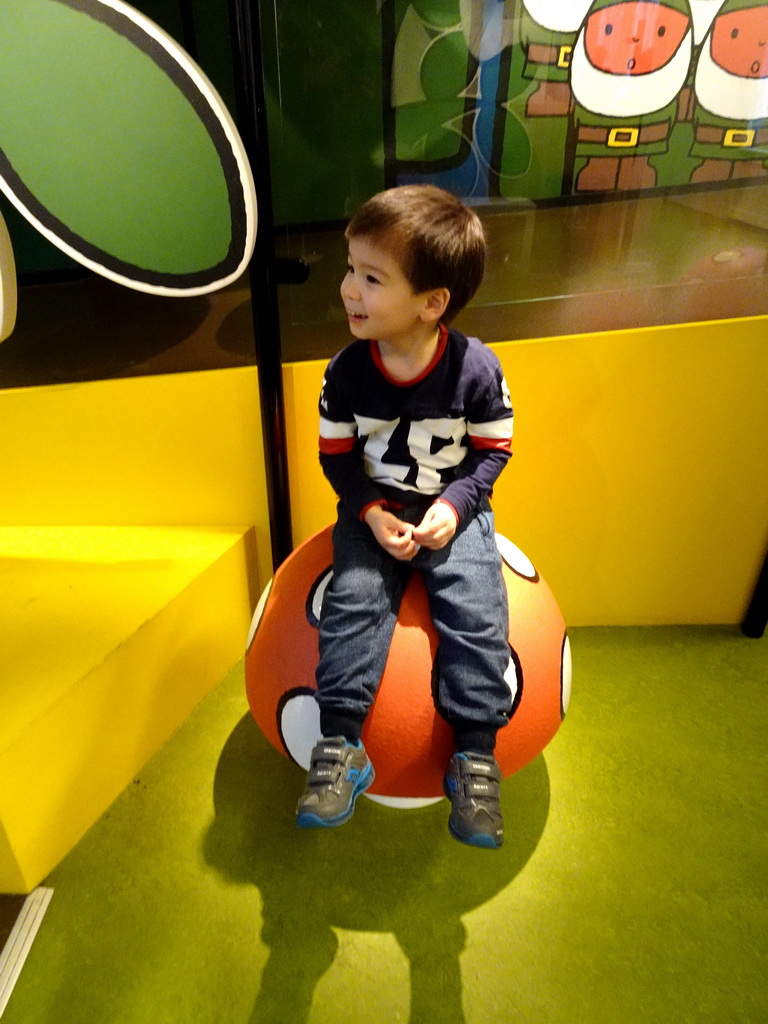 Max on a mushroom statue at the picnic area at the upper floor of the Nijntje Winter Museum