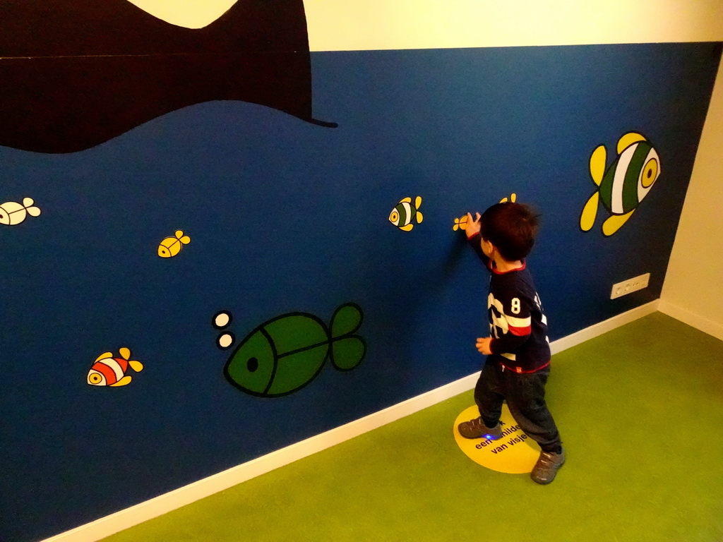 Max playing with cardboard fish at the Animal Room at the upper floor of the Nijntje Winter Museum