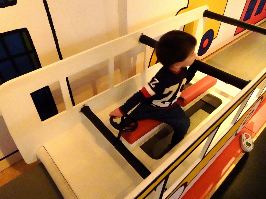 Max driving a bus at the Traffic Room at the upper floor of the Nijntje Winter Museum