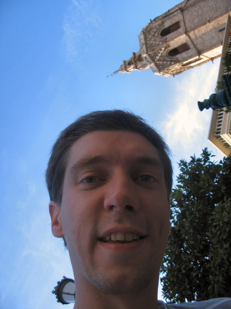 Tim with the tower of the Valencia Cathedral at the Plaça de la Reina square