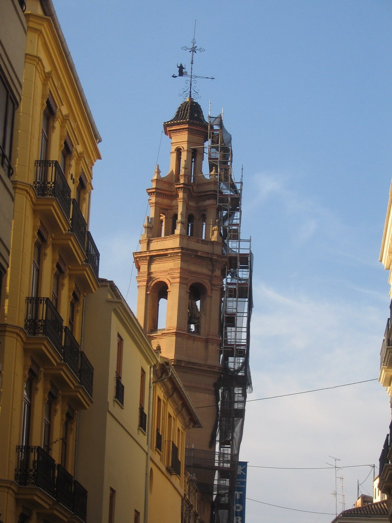 The tower of the Iglesia De San Lorenzo church at the Plaça de Sant Llorenç square, under renovation, at sunset