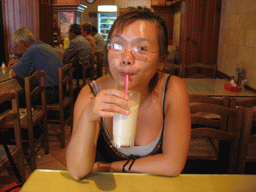 Miaomiao drinking Horchata at a restaurant in the city center