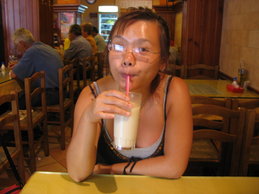 Miaomiao drinking Horchata at a restaurant in the city center