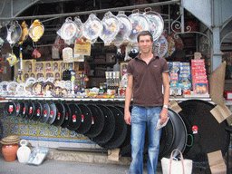 Tim in front of Paella pans at a street shop in the city center