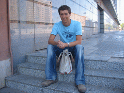 Tim sitting on a staircase in the city center