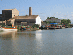 Boats and buildings on the shore of the Albufera lagoon, viewed from our tour boat