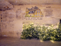 Christmas trees and a wall drawing for the 90 year anniversary of the VVV Geuldal building, at the christmas market at the Municipal Cave