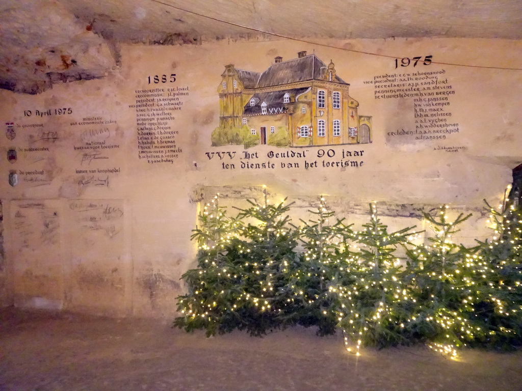 Christmas trees and a wall drawing for the 90 year anniversary of the VVV Geuldal building, at the christmas market at the Municipal Cave