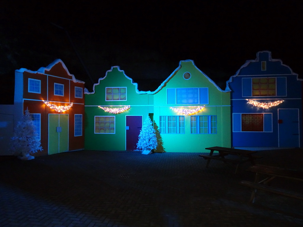 Facades of houses with christmas decorations at the entrance to the Winter Wonderland Valkenburg at the Wilhelmina Cave, by night
