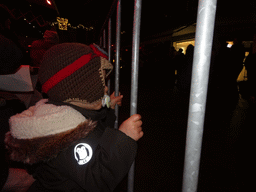 Max looking at the christmas parade at the Grotestraat Centrum street, by night