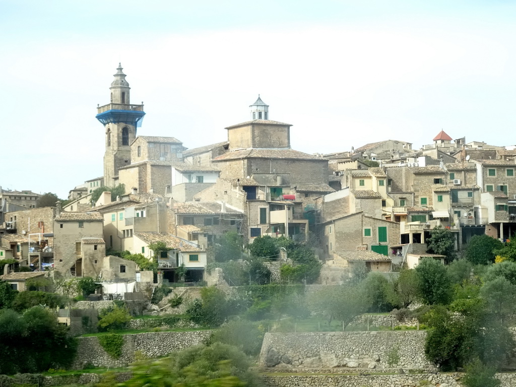 The east side of the town center with the tower of the Església de Sant Bartomeu church, viewed from the rental car on the Ma-1110 road