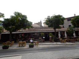 Restaurants at the Avinguda Palma street and the tower of the Iglesia dela Cartuja church