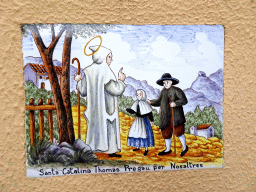 Tile with a painting with the text `Saint Catalina Thomas, pray for us` at a wall at the Carrer Marquès de Vivot street