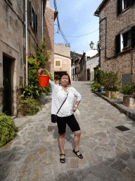 Miaomiao with a bucket at the Carrer Nicolau Calafat street