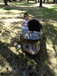 Max in a hedgehog statue at the Kabouterpad path at Zoo Veldhoven