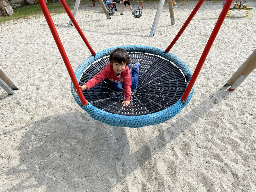 Max on a swing at the large playground at Zoo Veldhoven