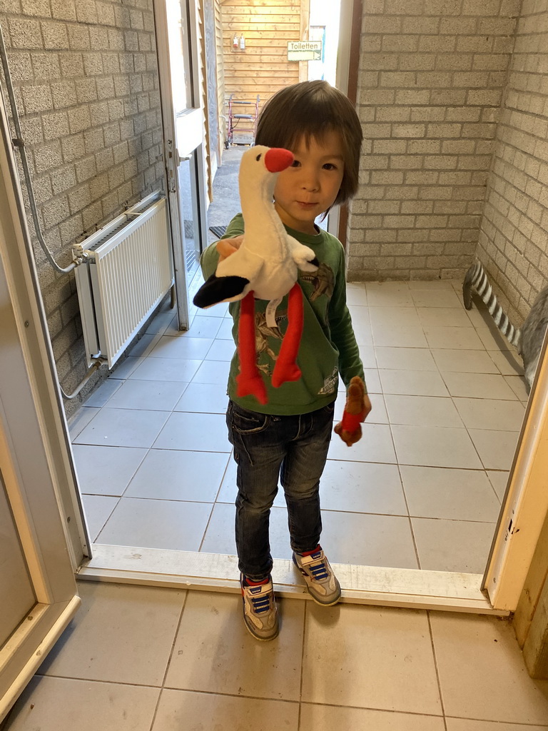 Max with a Stork toy in the souvenir shop of Zoo Veldhoven