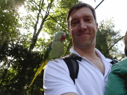 Tim with a Parrot on his shoulder in an Aviary at Zoo Veldhoven